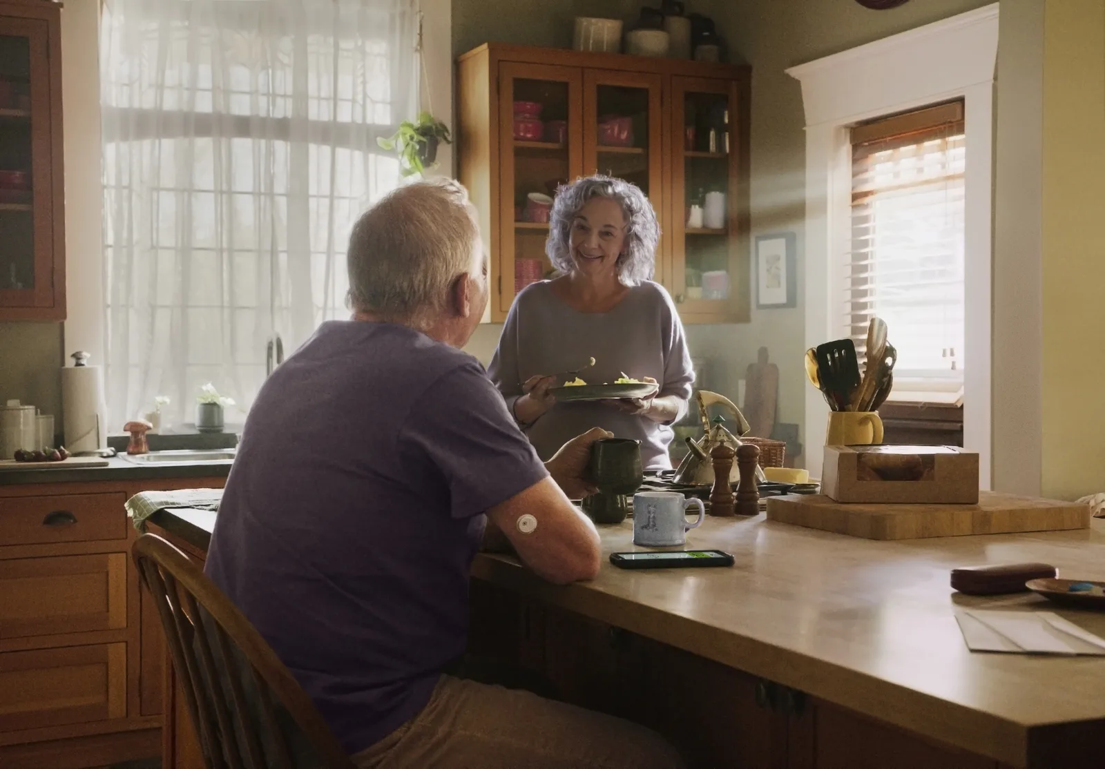An older couple in their kitchen in the morning
